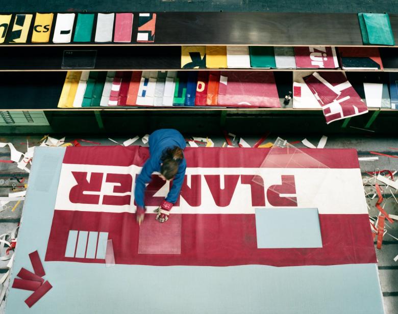 The truck tarps are hand-cut with a cutter knife