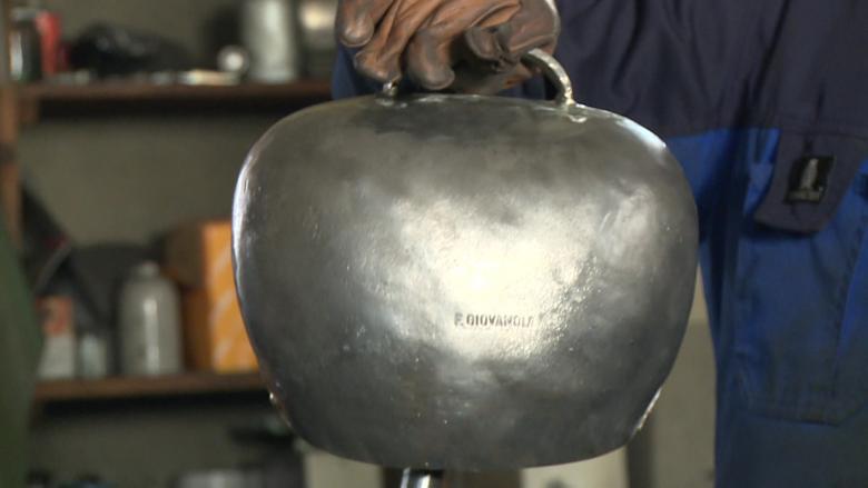 There are fifteen separate steps to producing a metal bell. François Giovanola proudly holds up a bell that is almost finished. 