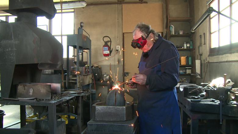 Welding the two rounded metal sides together to form the bell is a painstaking process. François Giovanola melts filler metal into the join between the two parts. 