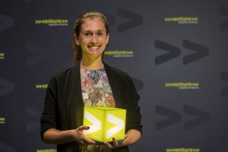Samantha Anderson holding the award for Switzerland's most innovative start-up, won by DePoly in July 2019. 