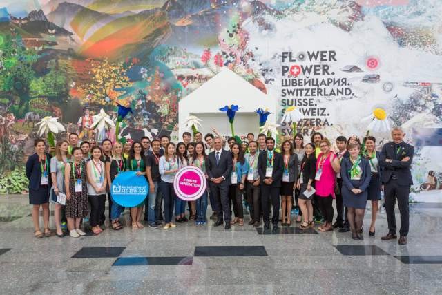 Team Presence Switzerland in front of the Swiss Pavilion and Federal Councilor Didier Burkhalter.